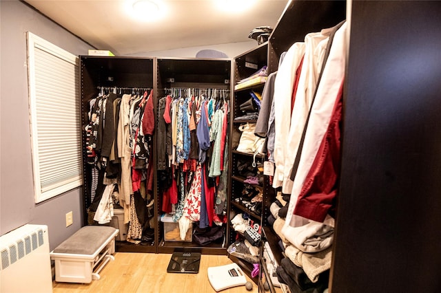 spacious closet with hardwood / wood-style floors and radiator