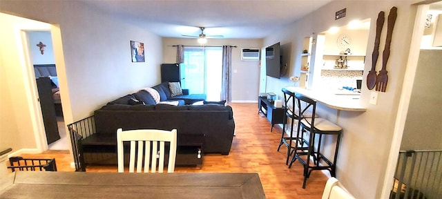 living room featuring radiator, wood-type flooring, and ceiling fan