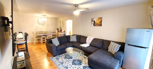 living room with hardwood / wood-style floors and ceiling fan