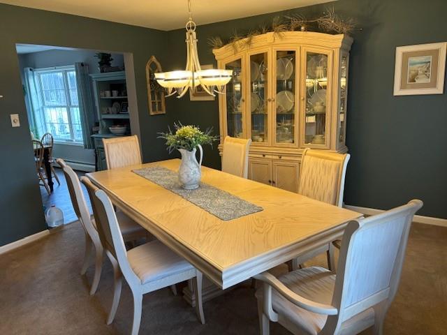 dining space featuring a notable chandelier and a baseboard heating unit