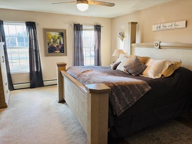 bedroom featuring ceiling fan, light carpet, and multiple windows