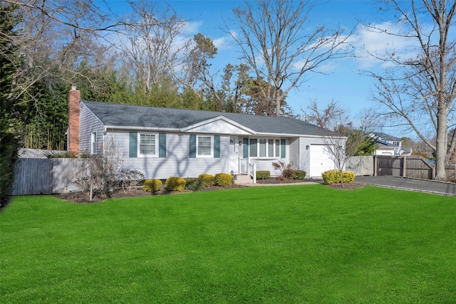 ranch-style house featuring a garage and a front yard