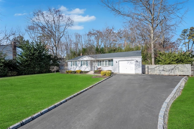 ranch-style home featuring a garage and a front lawn