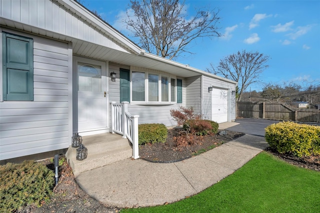 doorway to property with a garage