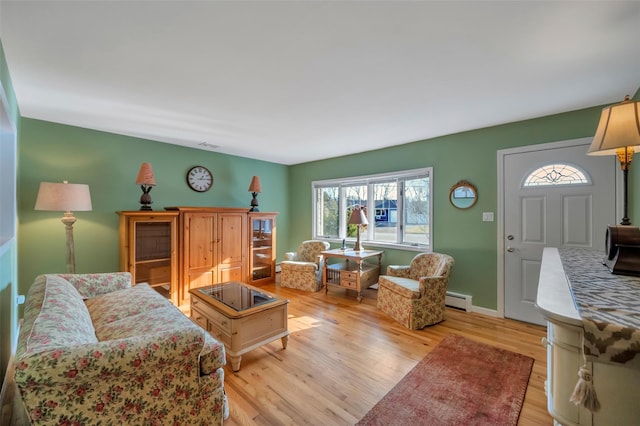 living room featuring a baseboard radiator and light wood-type flooring