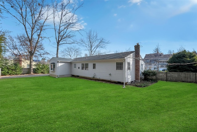 back of house featuring a yard