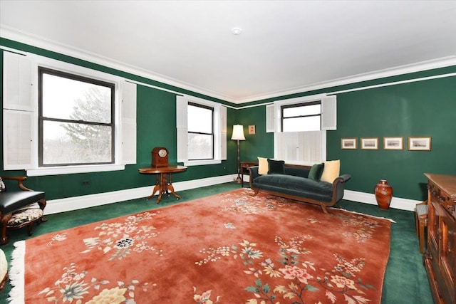 sitting room with dark carpet and ornamental molding