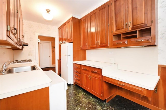 kitchen featuring white fridge and sink