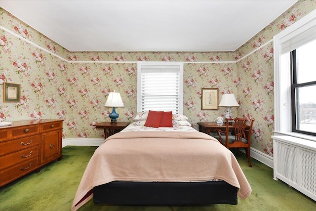 bedroom featuring carpet floors, radiator, and multiple windows