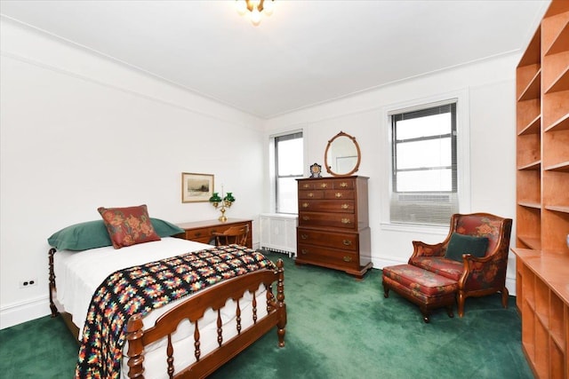 bedroom with dark carpet and radiator