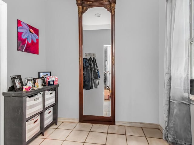 corridor with light tile patterned flooring