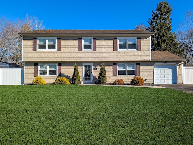 view of front facade with a garage and a front lawn