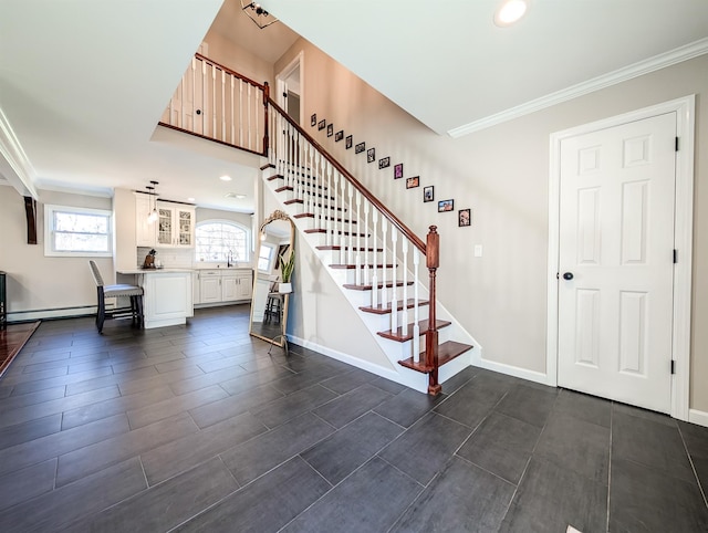 staircase featuring sink, a baseboard radiator, and crown molding