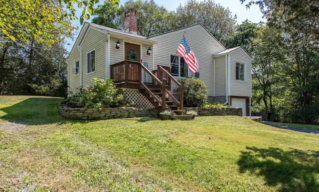 view of front of property featuring a front yard and a garage