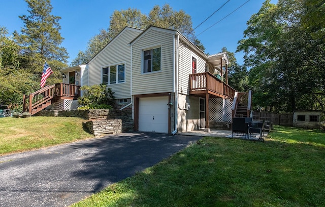 view of home's exterior featuring a deck, a lawn, and a garage