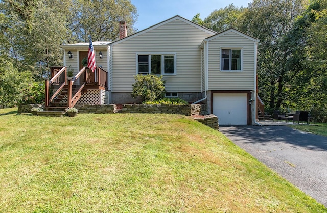 view of front of home with a front lawn and a garage