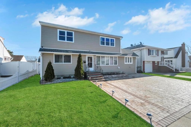 view of front of home with a front lawn and a garage