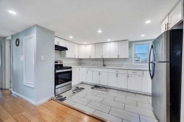 kitchen featuring white cabinets, stainless steel electric stove, fridge, and sink