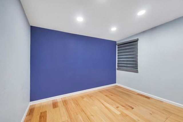 unfurnished room featuring recessed lighting, baseboards, and wood finished floors