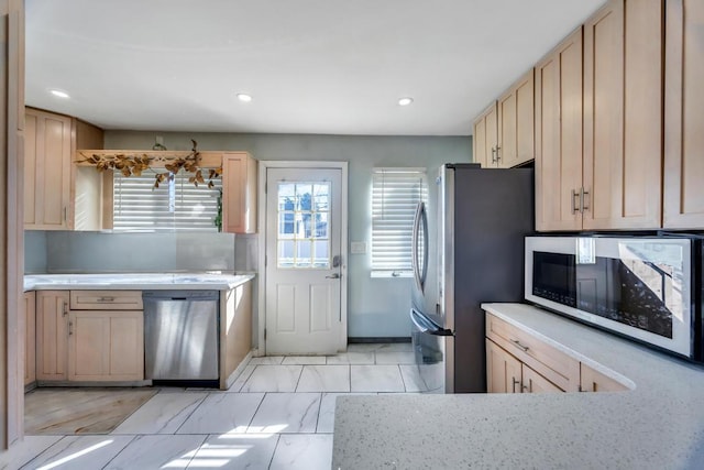 kitchen with marble finish floor, light brown cabinets, recessed lighting, stainless steel appliances, and light countertops