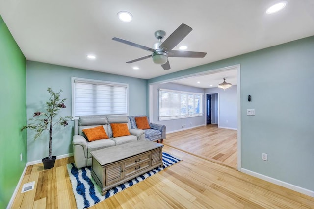 living room with visible vents, ceiling fan, baseboards, recessed lighting, and wood finished floors