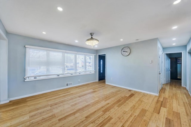 unfurnished room featuring recessed lighting, visible vents, and light wood-style floors