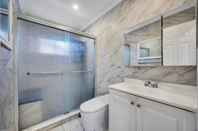 bathroom with toilet, a stall shower, vanity, and tile walls