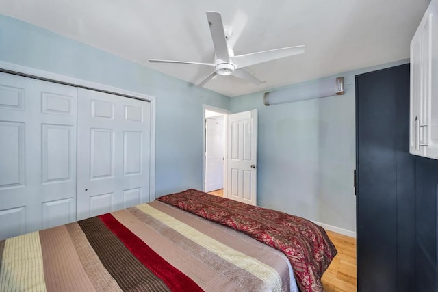 bedroom featuring a ceiling fan, a closet, and light wood-type flooring