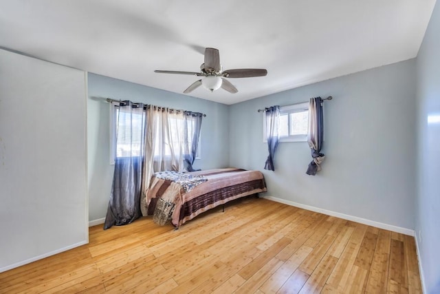 bedroom featuring ceiling fan, baseboards, and wood-type flooring