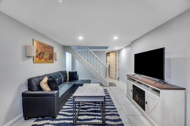 living area featuring recessed lighting, stairway, baseboards, and marble finish floor