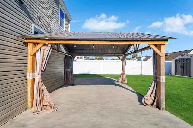 view of vehicle parking featuring a storage shed and a fenced backyard