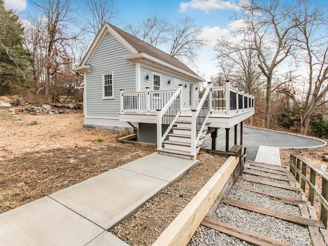 view of front of home with a wooden deck and a sunroom