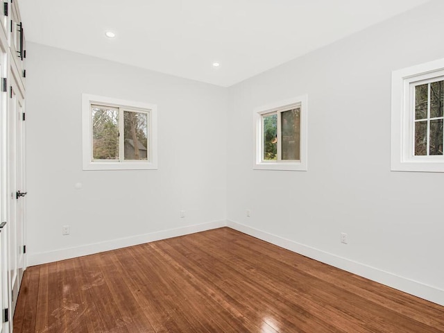 empty room with hardwood / wood-style flooring