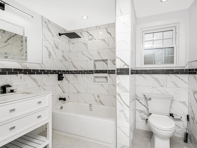 full bathroom with toilet, vanity, tile walls, and tiled shower / bath combo