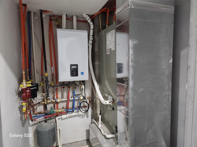 utility room with tankless water heater