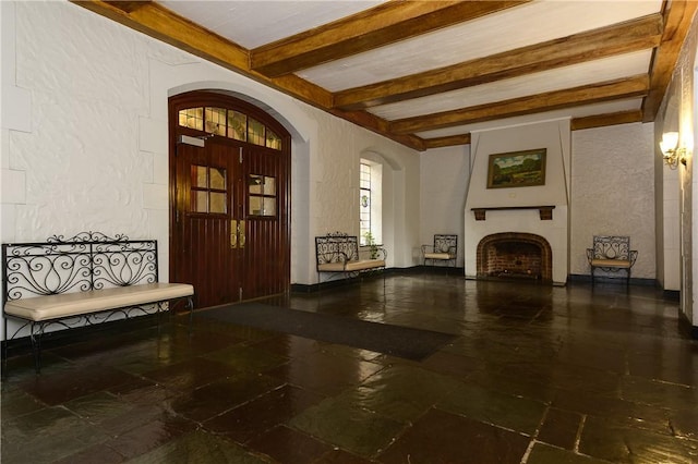 foyer featuring beam ceiling