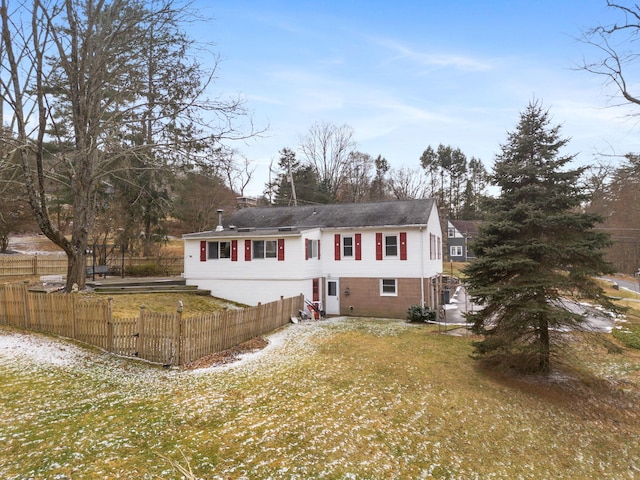 split foyer home with a front lawn