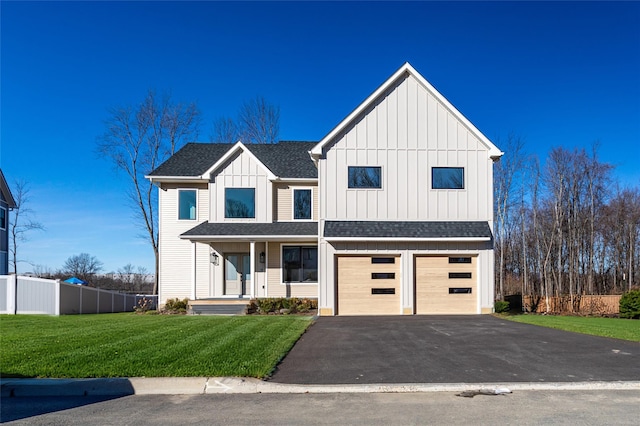 modern farmhouse with covered porch, a front lawn, and a garage