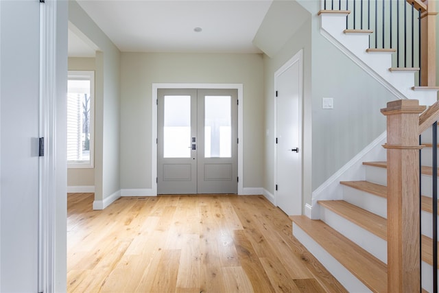 foyer featuring light hardwood / wood-style flooring and french doors