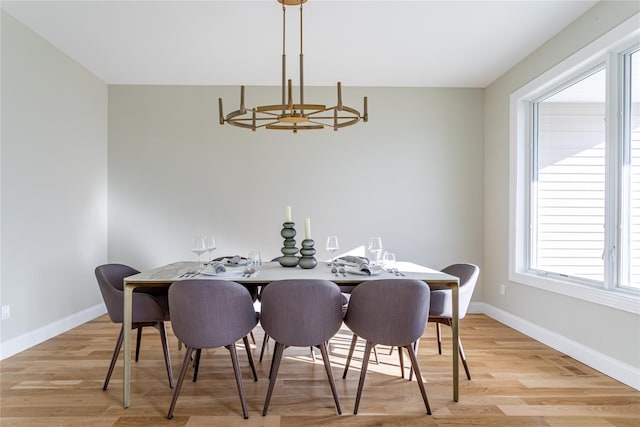 dining room featuring light hardwood / wood-style flooring and a chandelier