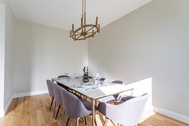 dining room featuring a notable chandelier and light hardwood / wood-style flooring