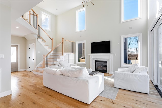 living room with a high ceiling and light hardwood / wood-style flooring