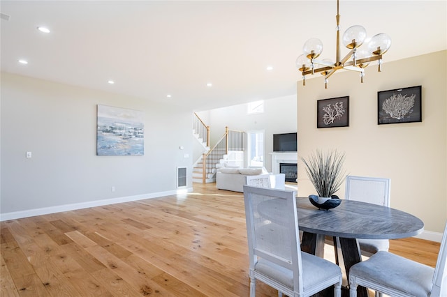 dining space with an inviting chandelier and light wood-type flooring