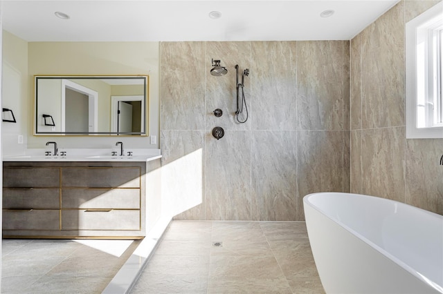 bathroom featuring shower with separate bathtub and vanity