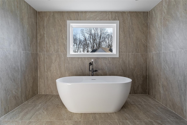 bathroom with a tub to relax in