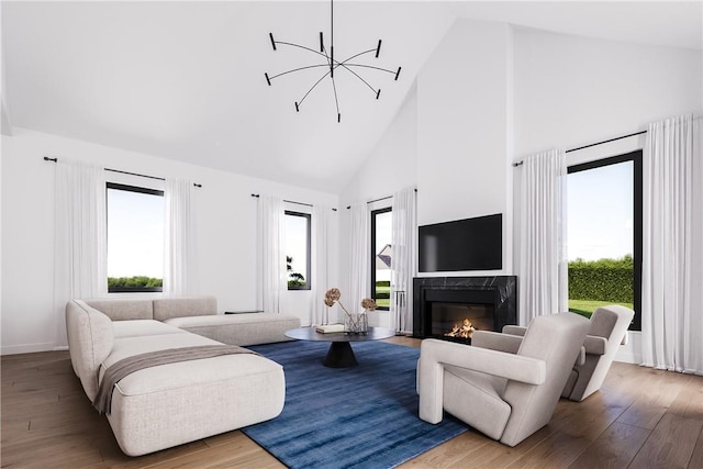 living room with a chandelier, high vaulted ceiling, a fireplace, and hardwood / wood-style flooring