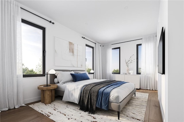 bedroom featuring radiator and light hardwood / wood-style floors