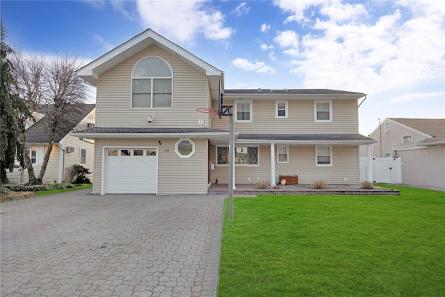 view of property with a front yard and a garage