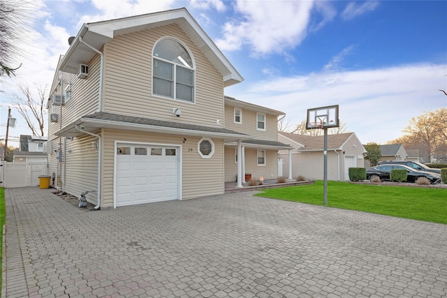 view of front facade with a garage and a front lawn