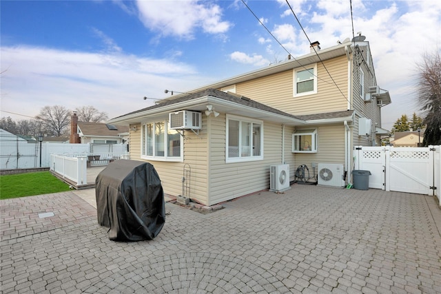 back of house featuring ac unit, an AC wall unit, and a patio